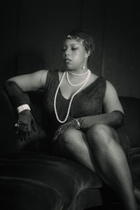 a woman in black and white sitting on a couch