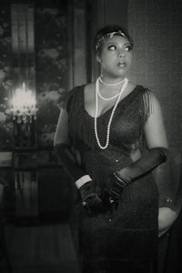 a black and white photo of a woman in a dress